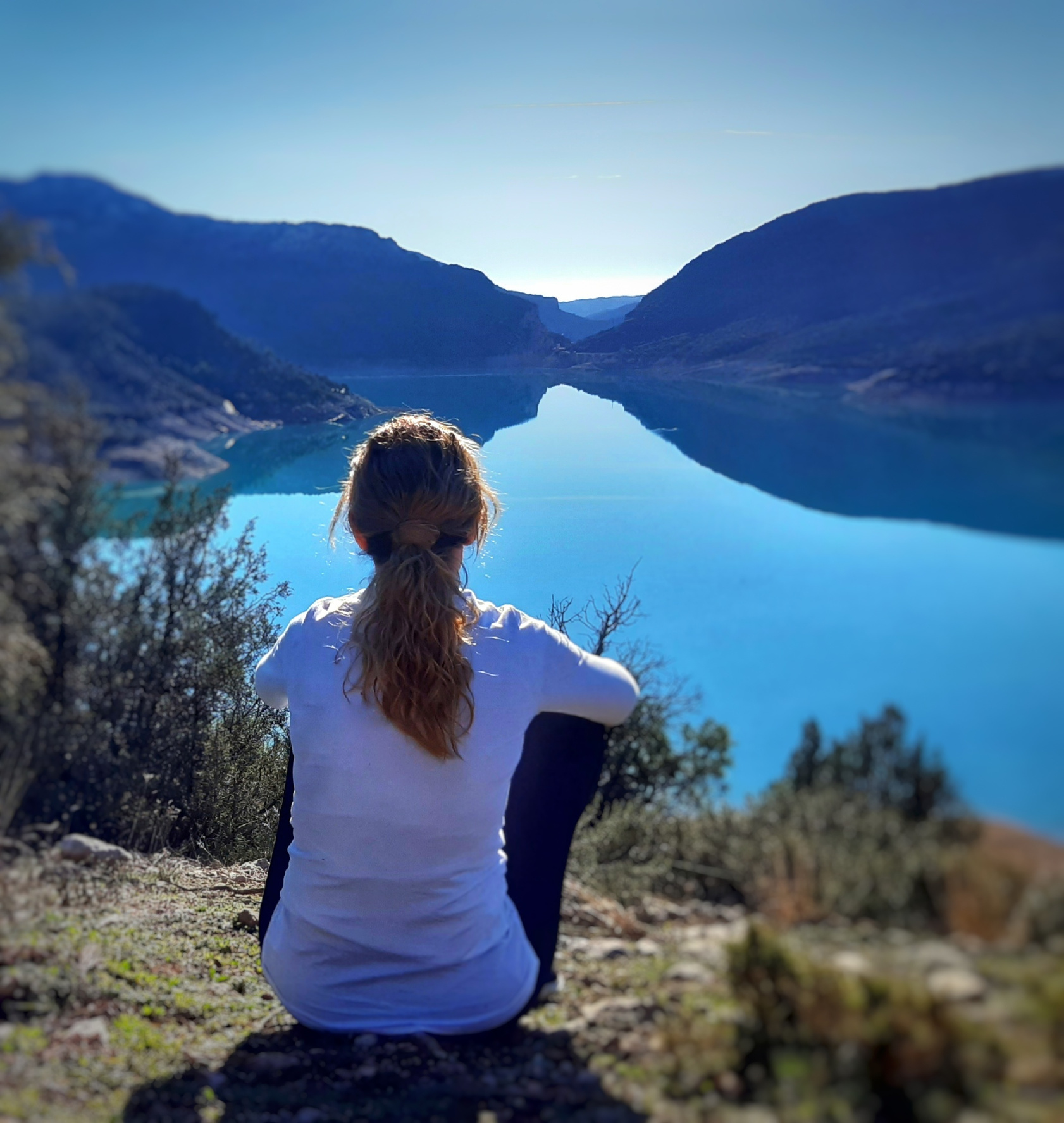 Girl looking at the horizon in calm